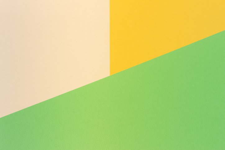 Overlapping cream, yellow, and green paper shapes